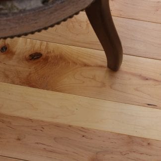 maple flooring in the natural character grade features occasional knots and color variation between the lighter sapwood and darker heartwood.