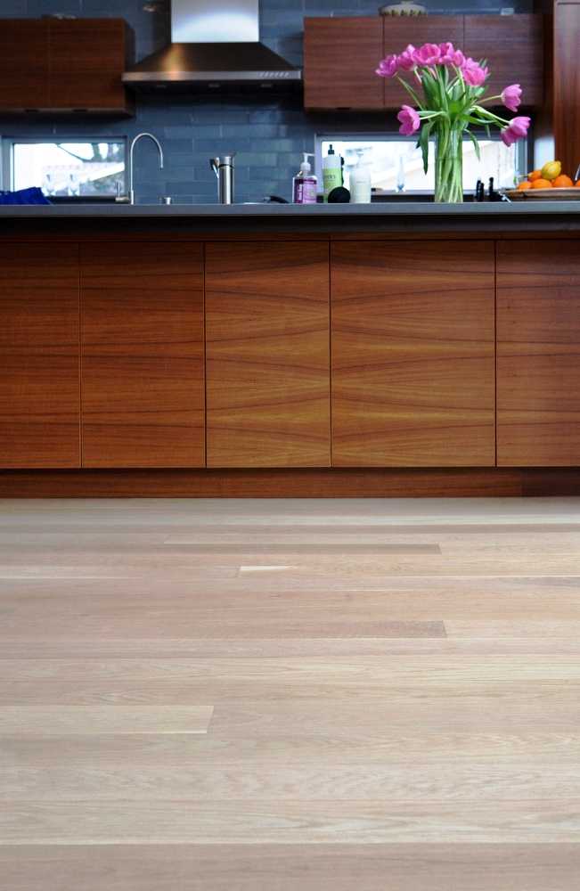 Figure 6: Light colored select grade White Oak (Hull wide plank floor #211) with five inch plank widths, finished with a water-based poly. The floors provide a pleasing contrast to the kitchen's darker cabinetry.