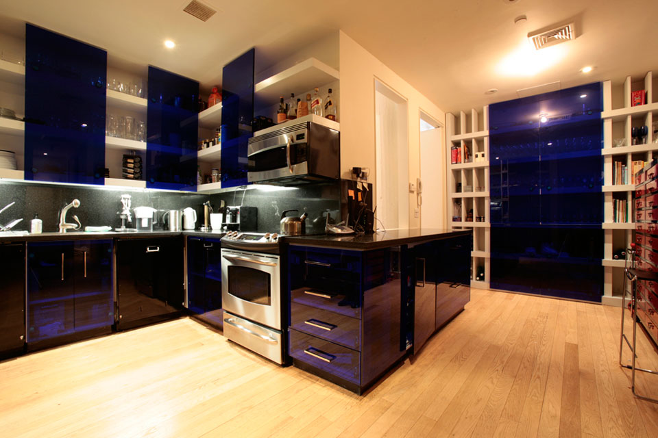 Long plank Red Oak floors emphasize the wide open space of this Soho loft kitchen.