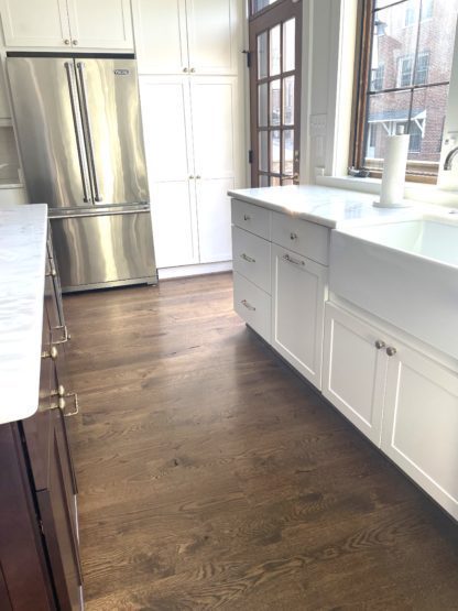 white kitchen with dark stain wood floor