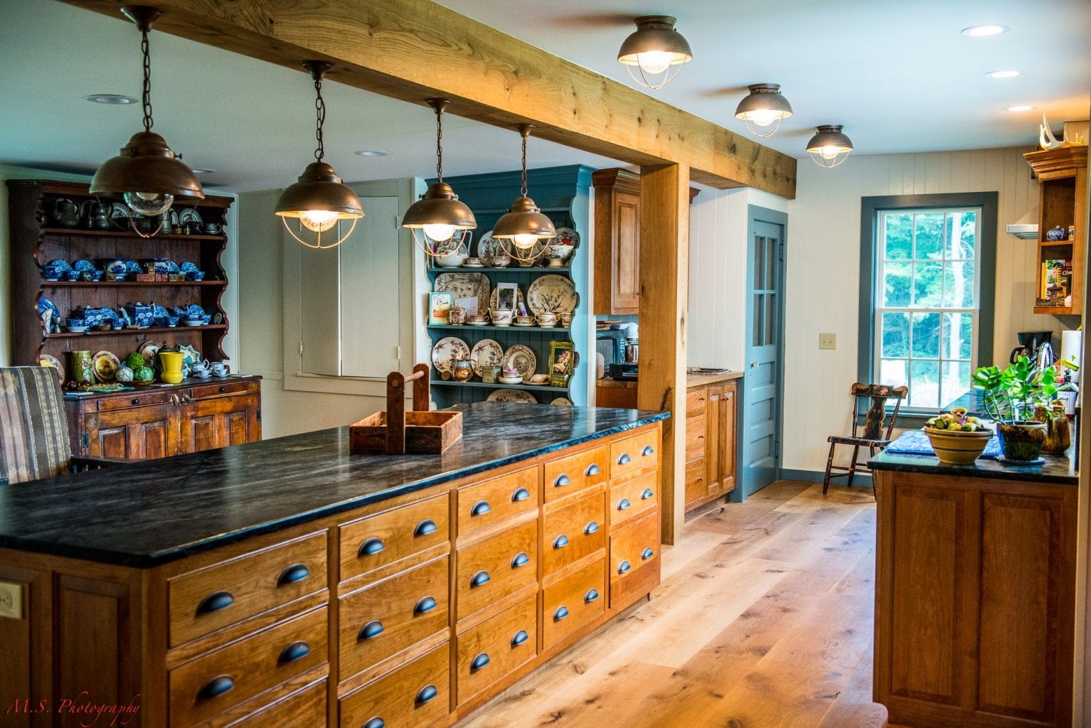White painted solid bead board paneling on the walls and live sawn white oak wide plank flooring