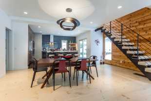 White stained wide plank pine flooring adds modern flair to a lakehouse.